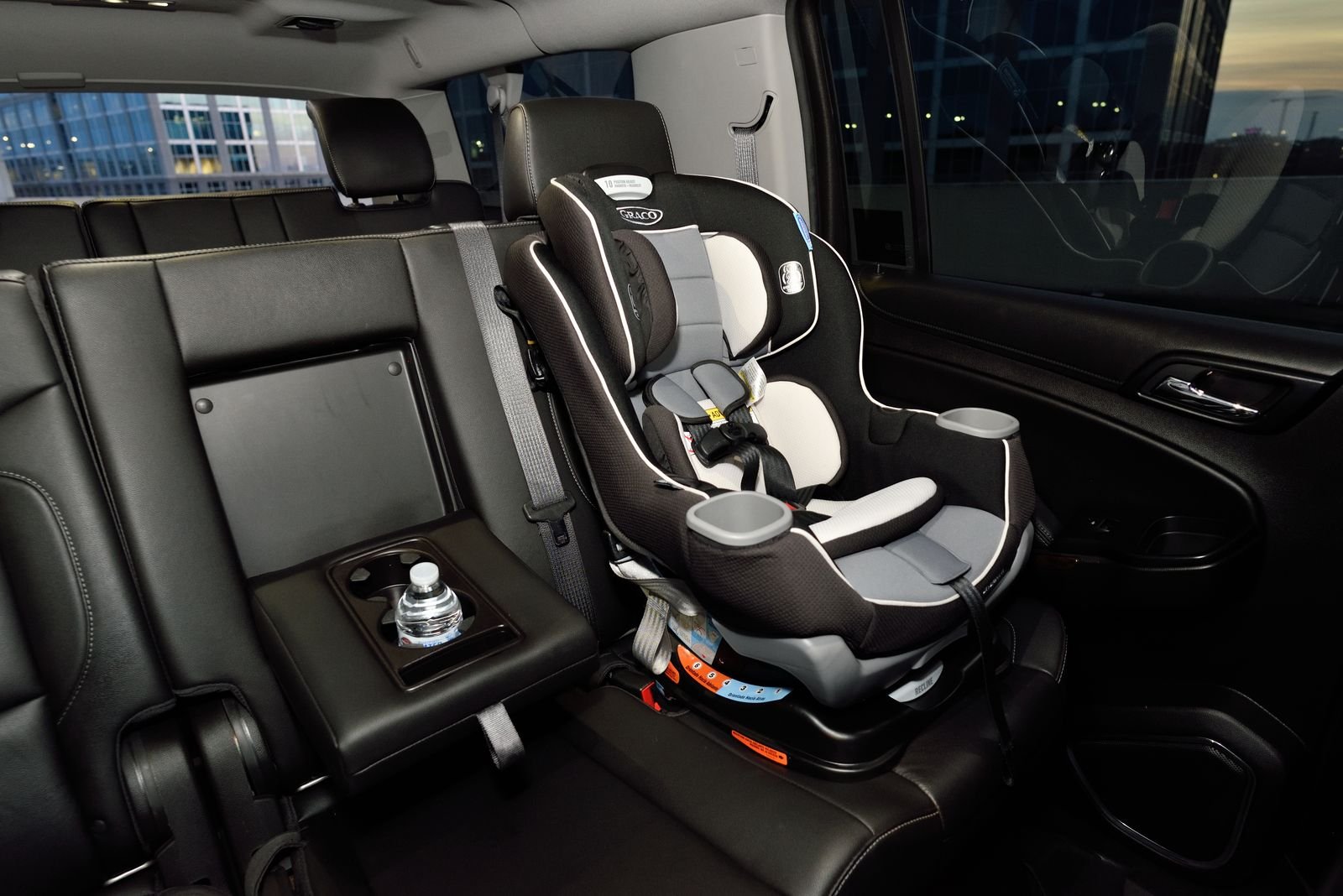 Child car seat installed in the leather rear cabin of a Lux4Rides luxury SUV