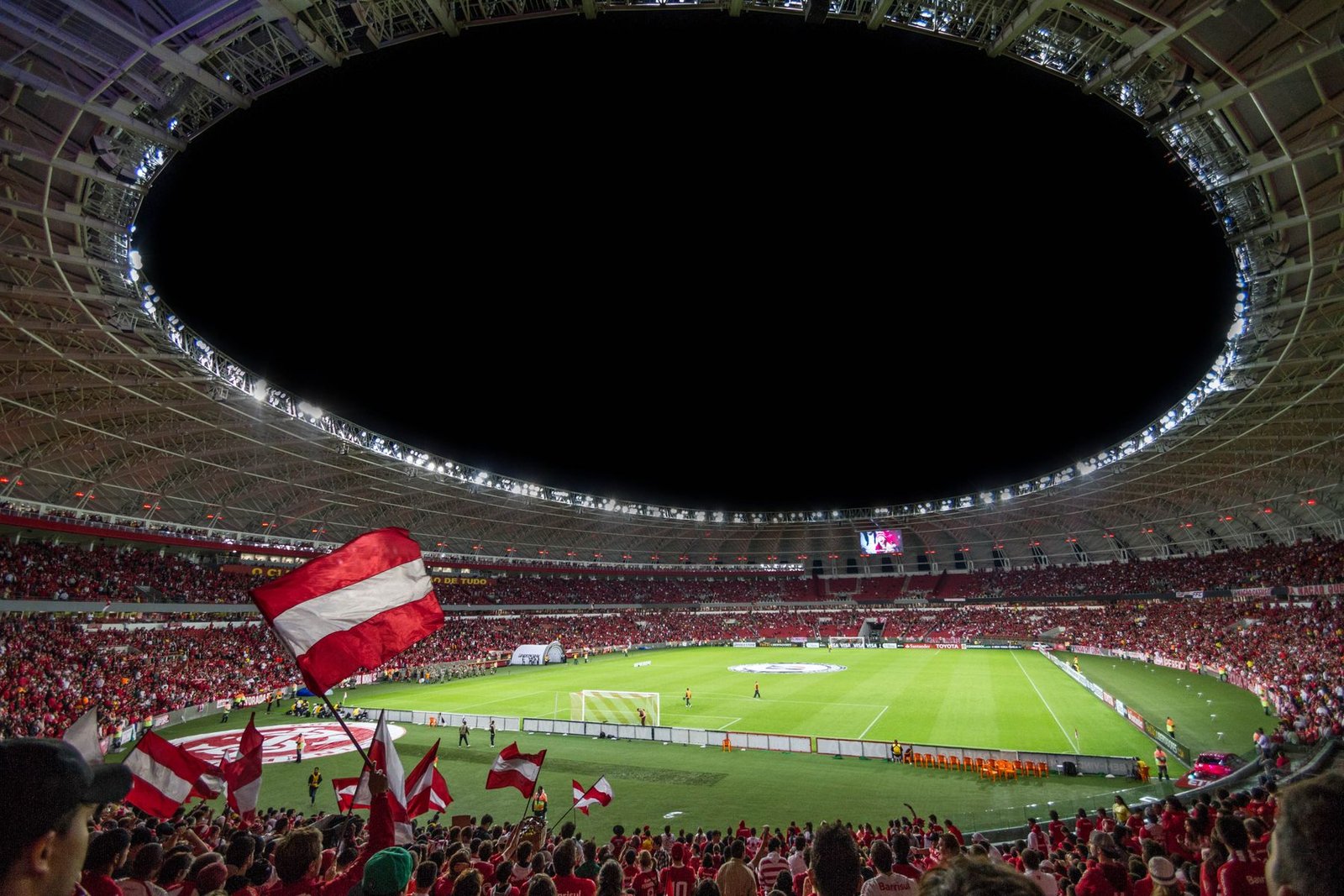 Packed soccer stadium under floodlights on a World Cup match night