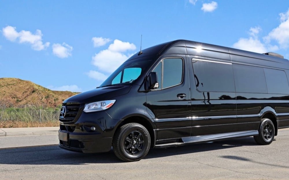Black Mercedes-Benz Sprinter passenger van photographed outdoors