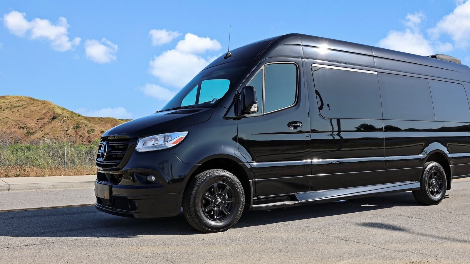 Black Mercedes-Benz Sprinter executive van from our Los Angeles fleet, photographed from the front three-quarter angle