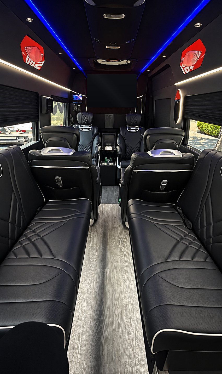 Jet Sprinter, Los Angeles — side lounge benches and VIP captain's chairs under blue LED lighting